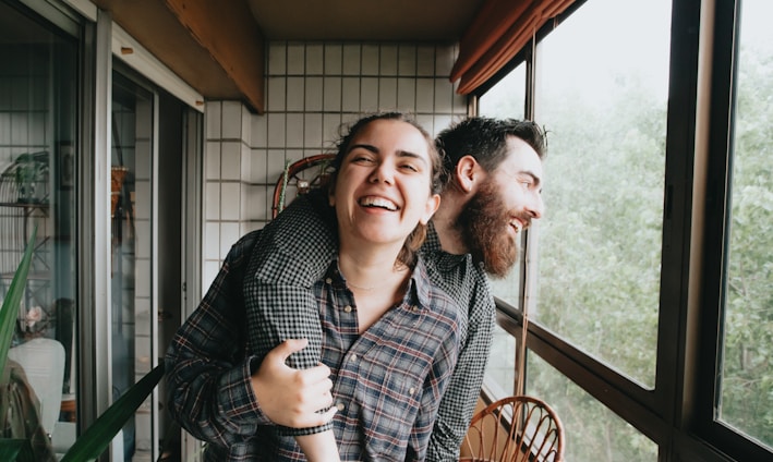 man and woman sitting on chair