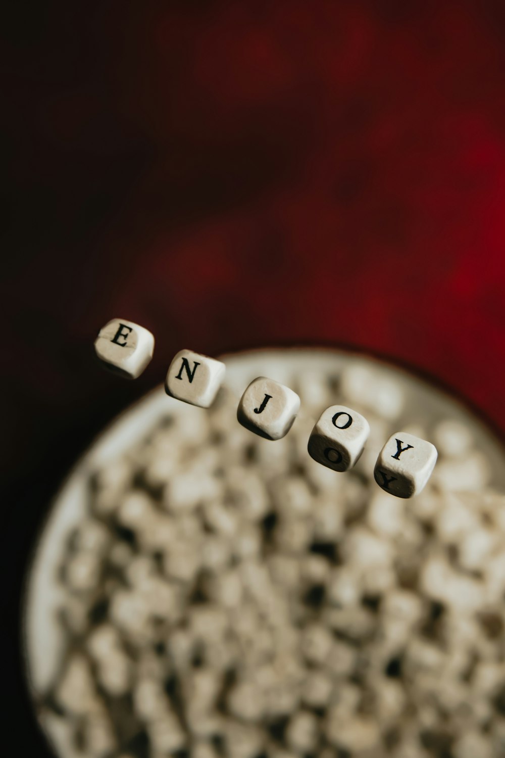 white and black dice on red textile