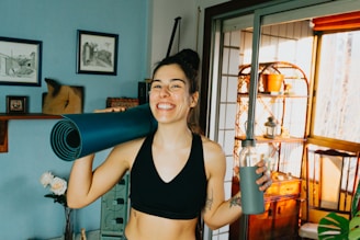 woman in black sports bra holding blue and black kettle