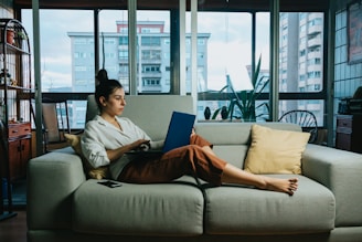 woman in white long sleeve shirt sitting on white couch