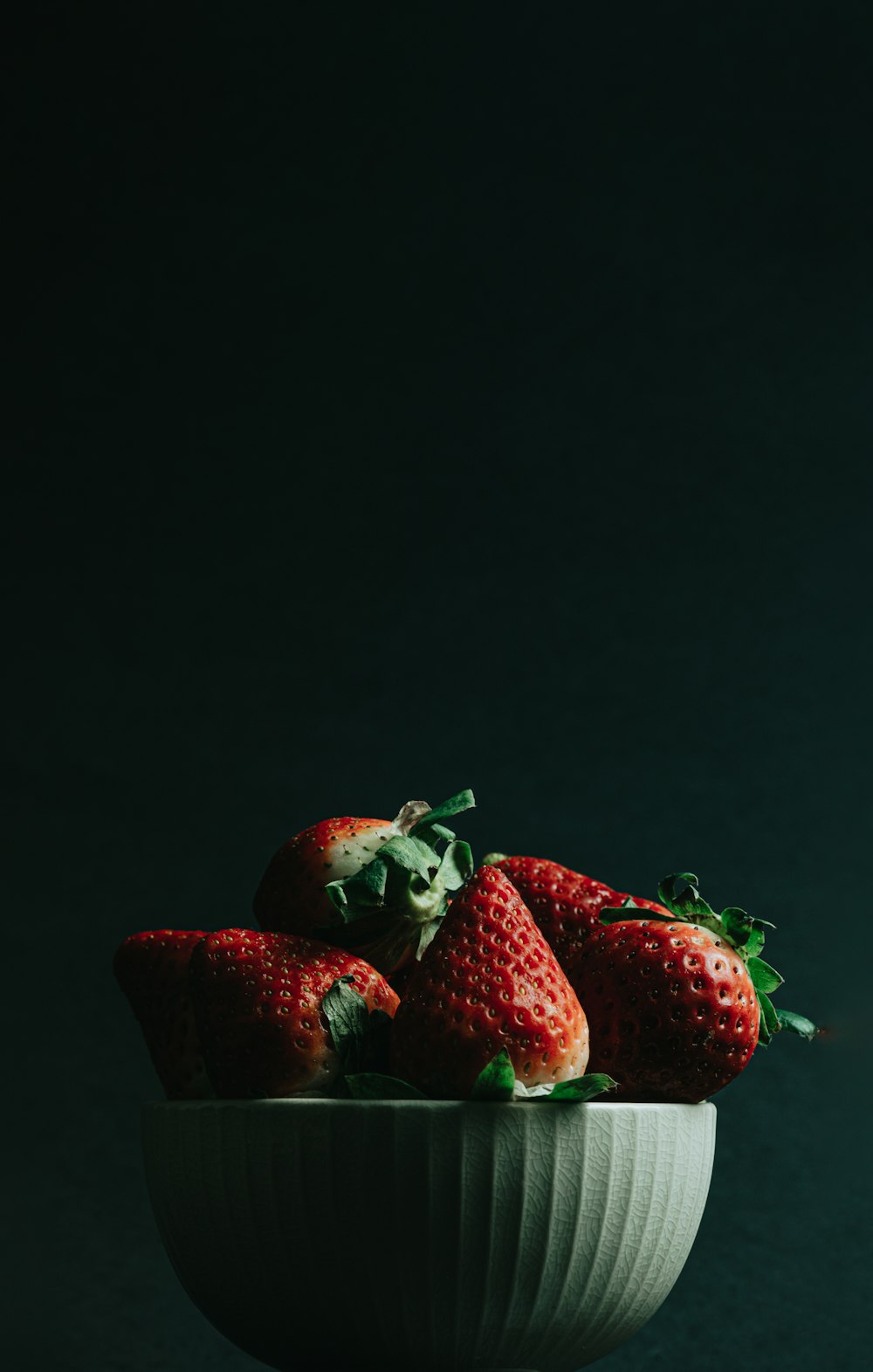 red strawberries on black surface