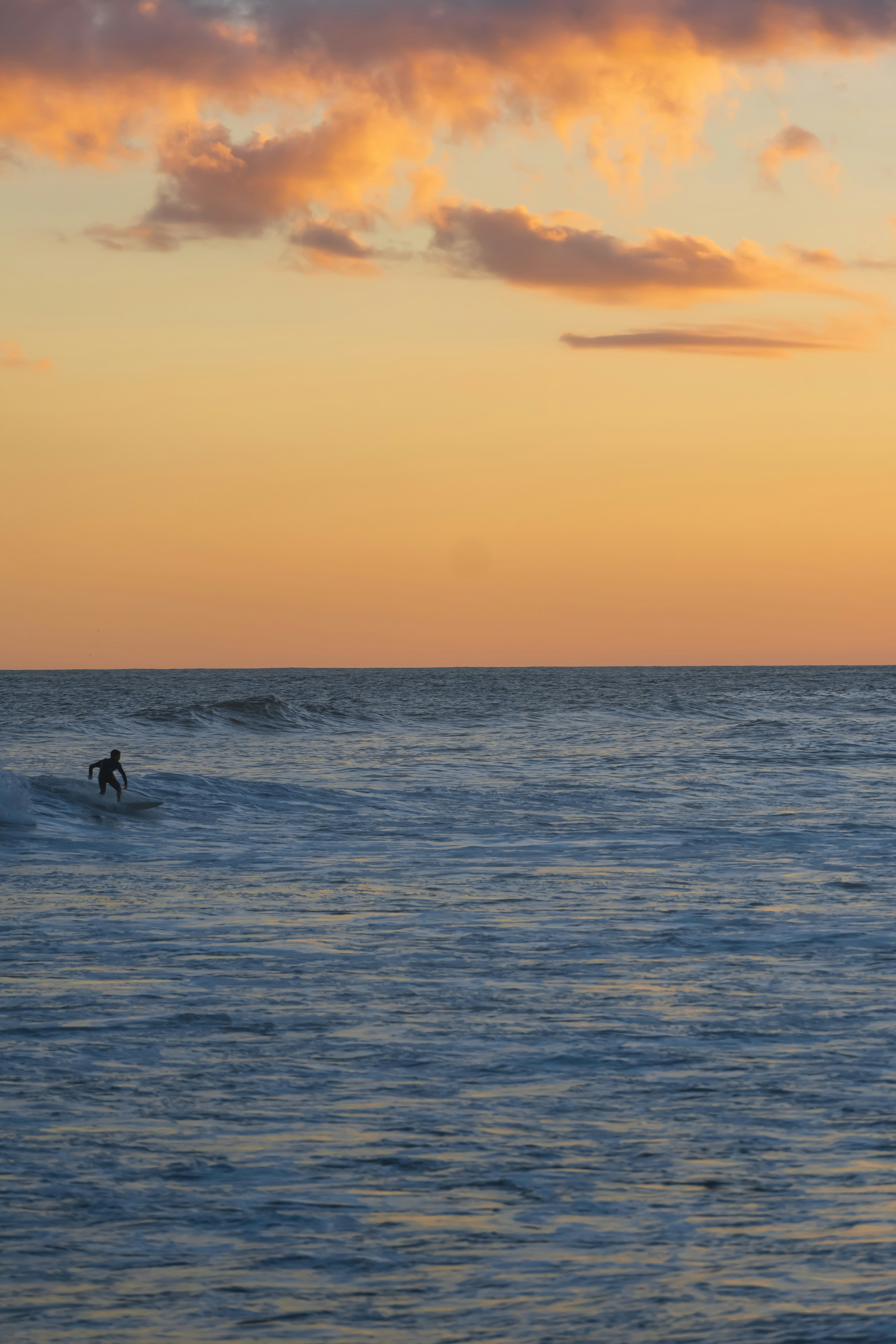 2 People Surfing On Sea During Sunset Photo Free Brasil Image On Unsplash