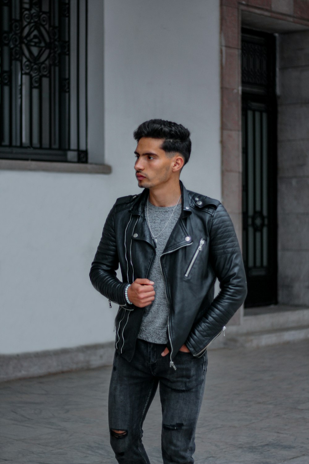 Man in black leather jacket standing near white wall during daytime photo –  Free Maroc Image on Unsplash