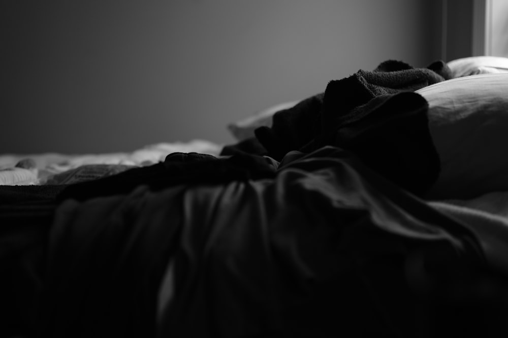grayscale photo of bed linen