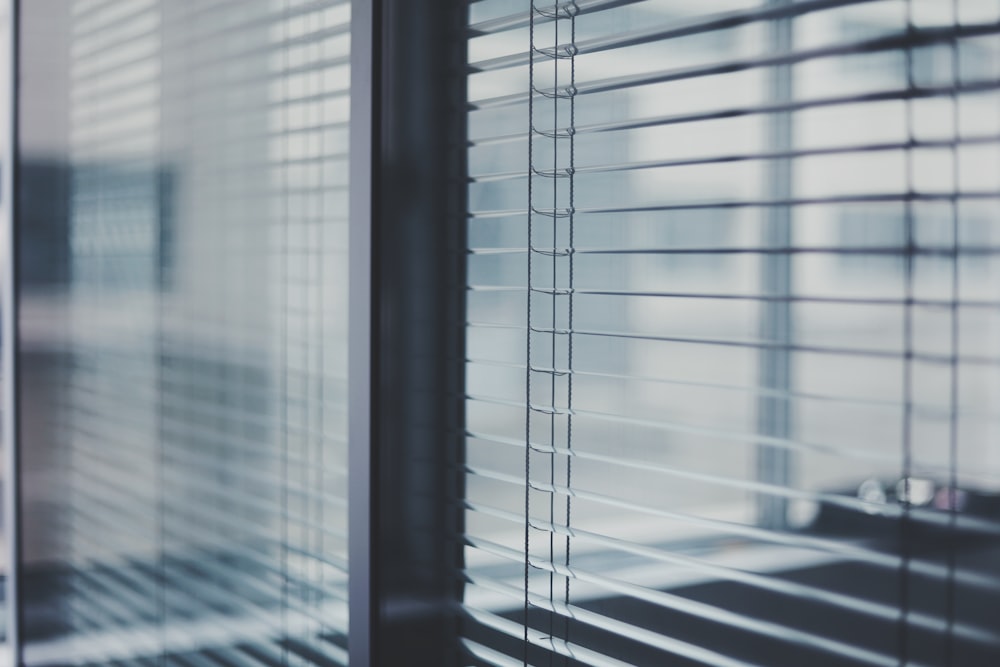 black framed glass window with white window blinds