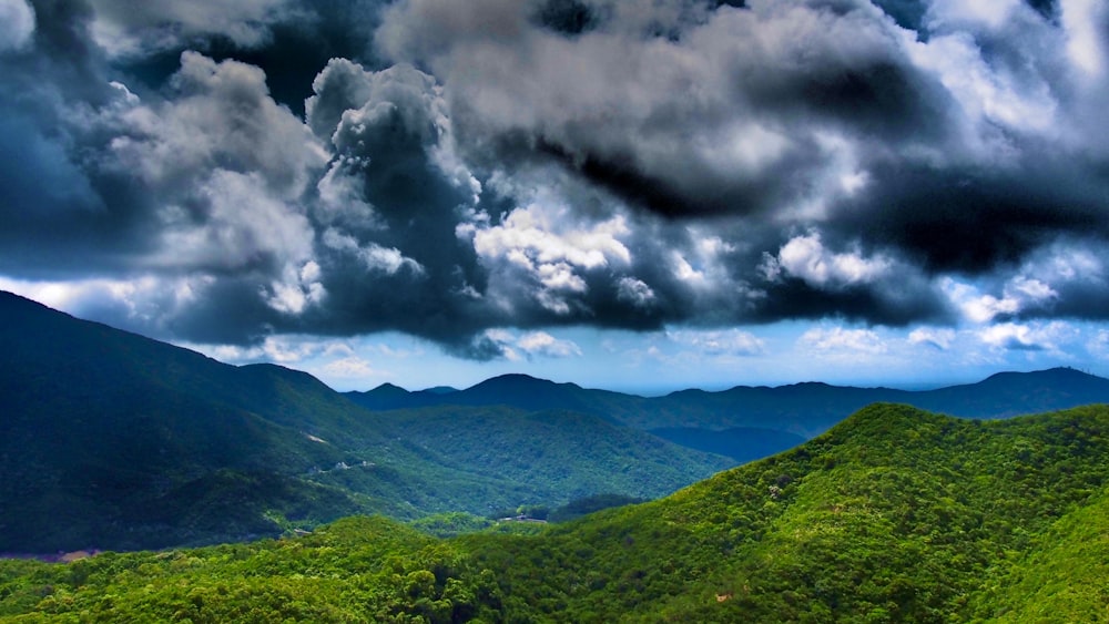 green mountains under white clouds