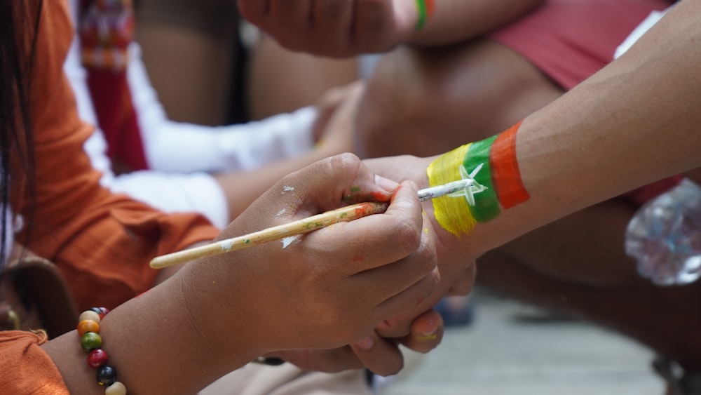 person holding green and white tube