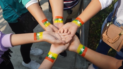 person with orange and yellow band aid on hands