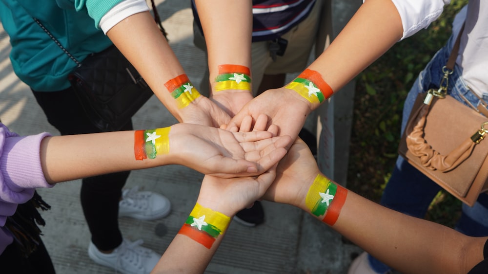 person with orange and yellow band aid on hands