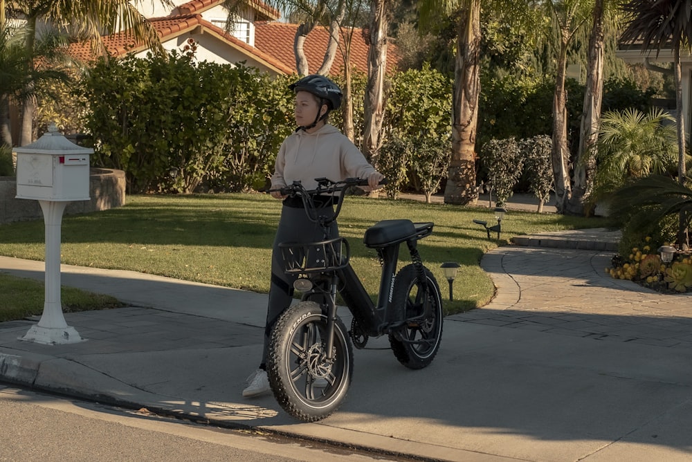 man in black jacket riding on black motorcycle on road during daytime