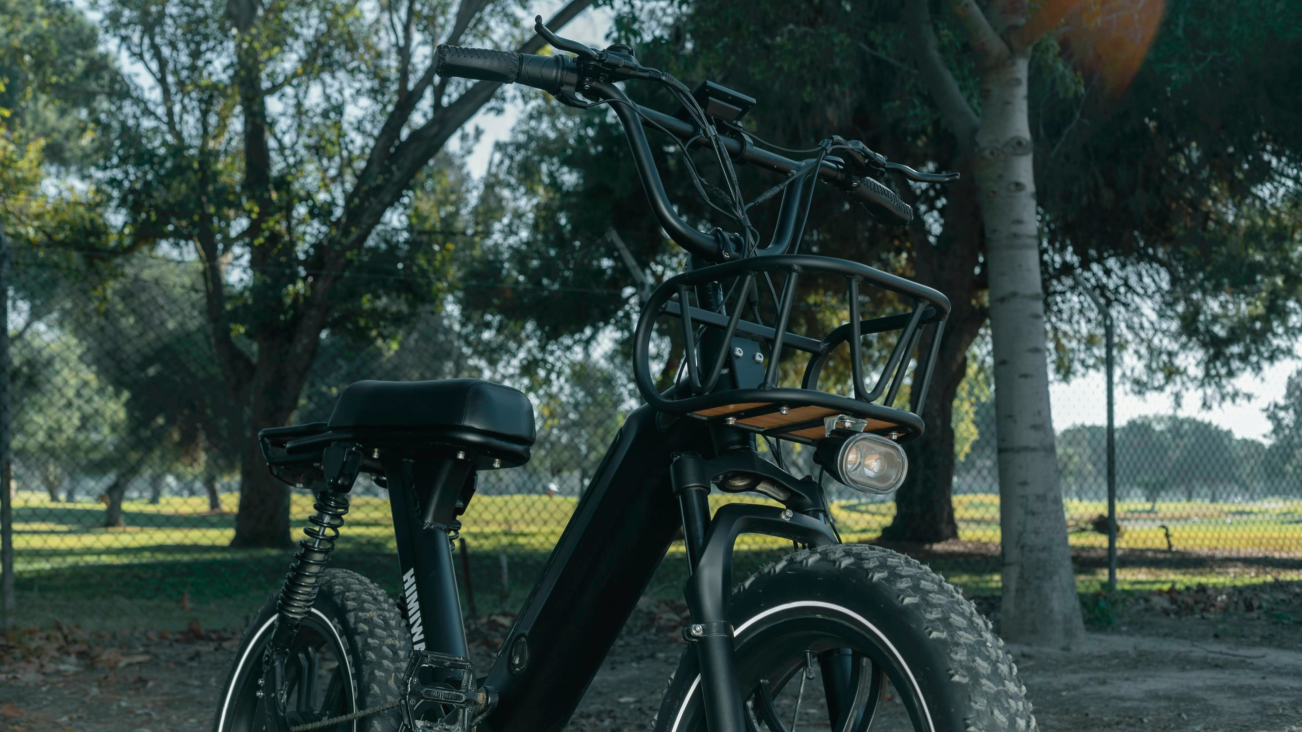 black and brown bicycle near green trees during daytime