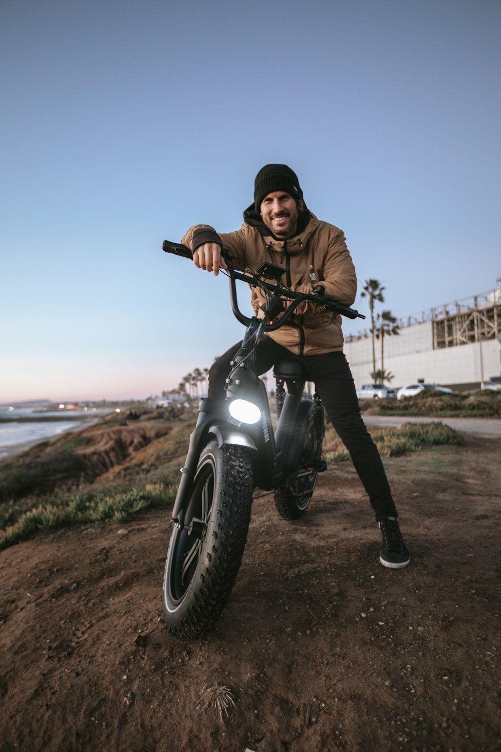 man in brown jacket riding black motorcycle during daytime