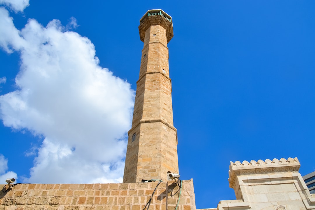 beige concrete tower under blue sky during daytime