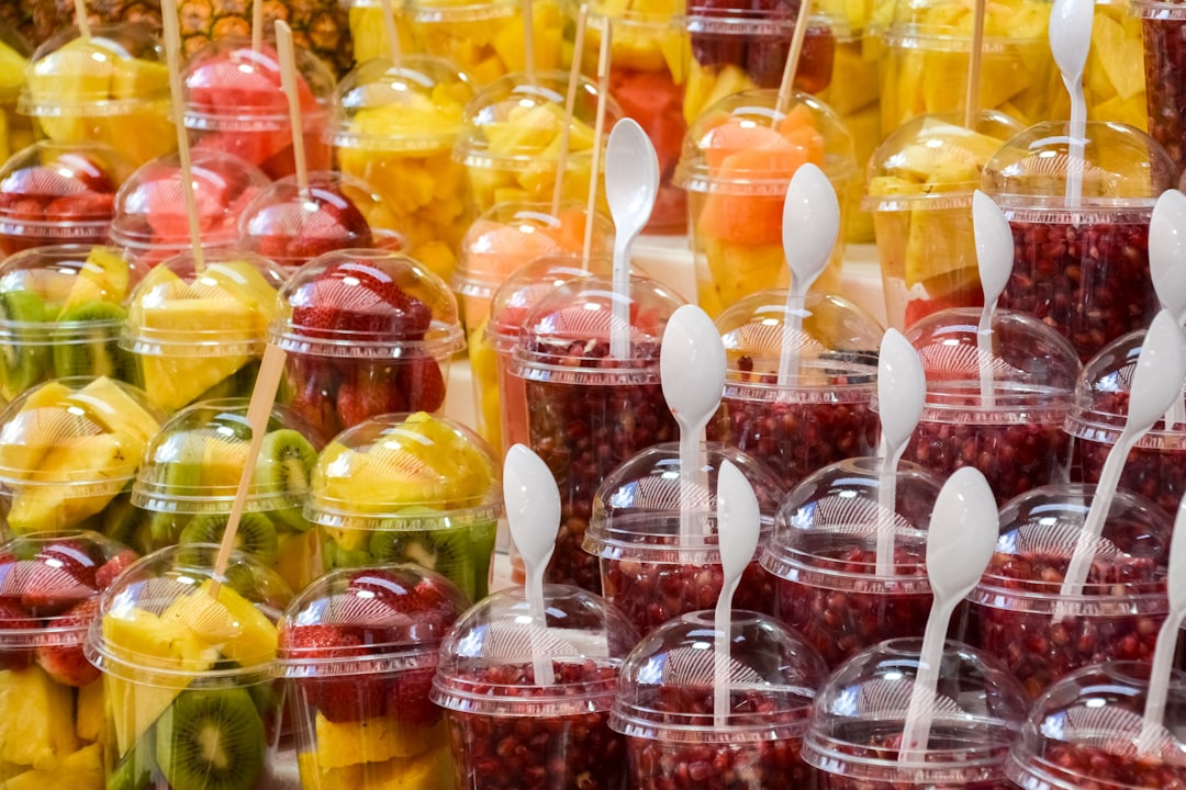 yellow and red candies in clear plastic cups