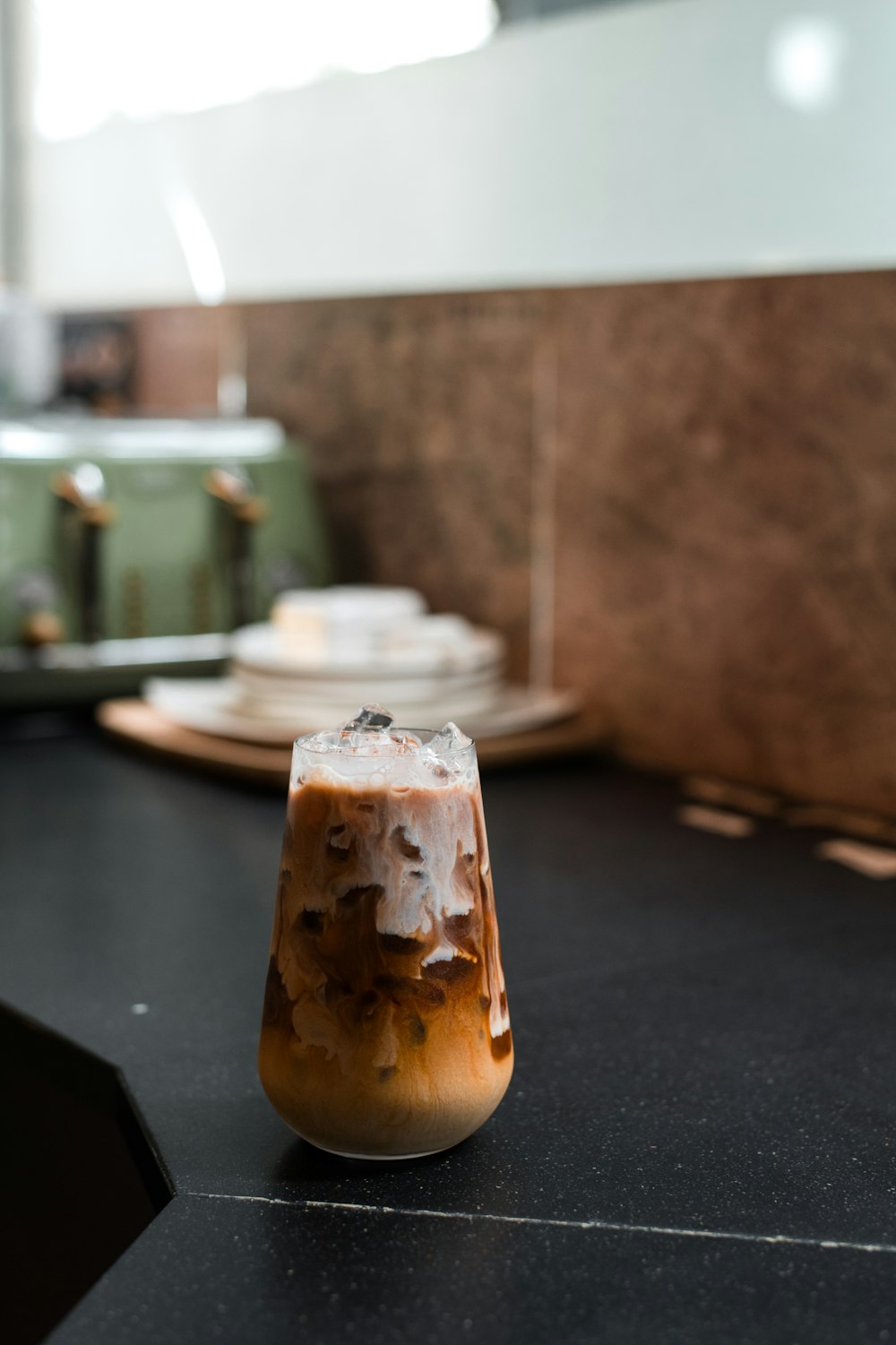 brown and white ice cream in clear glass jar