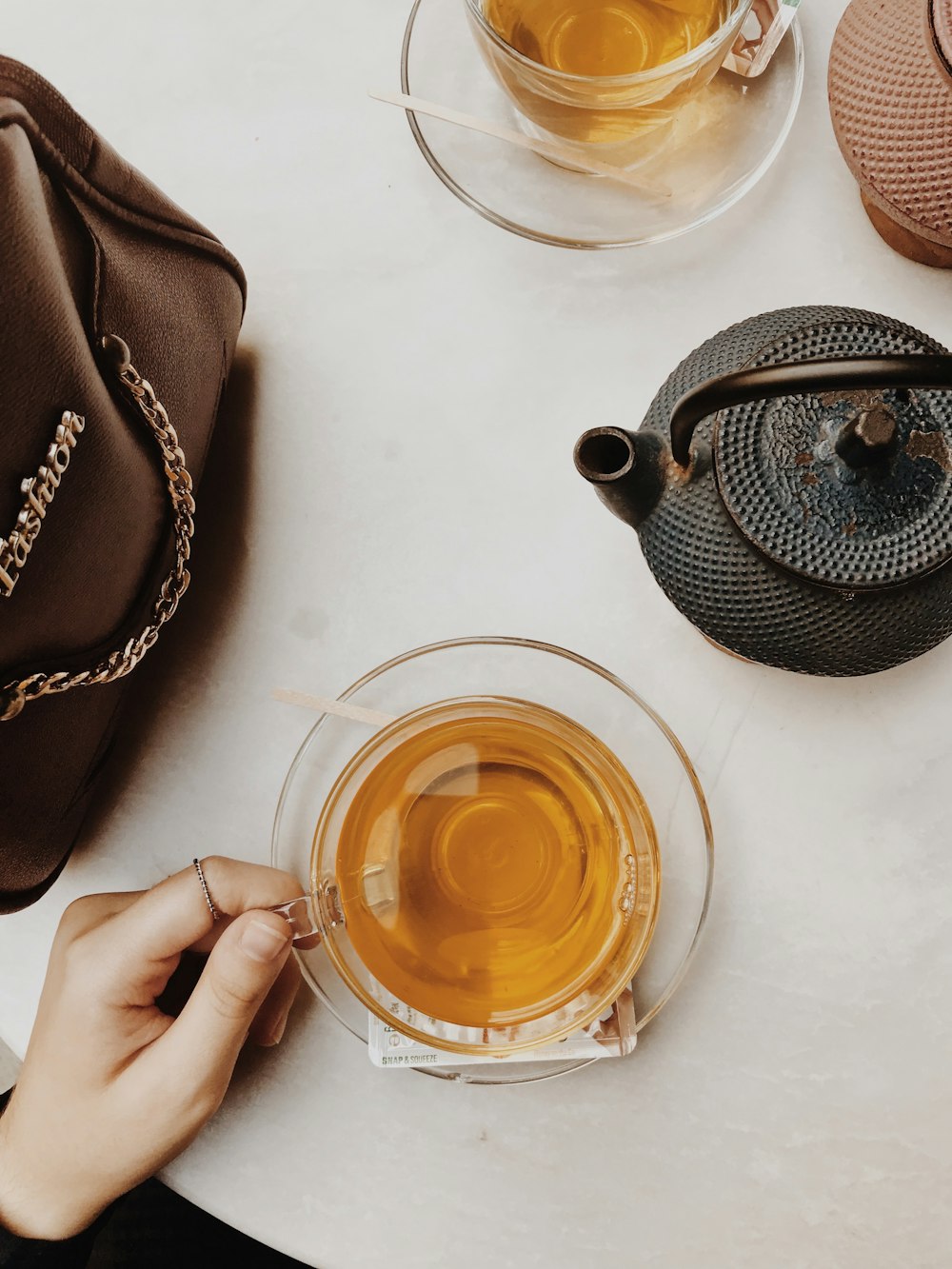 black ceramic teapot on white ceramic saucer