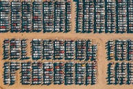 Rows of salvaged vehicles neatly organized in the SwiftShift Logistics lot.