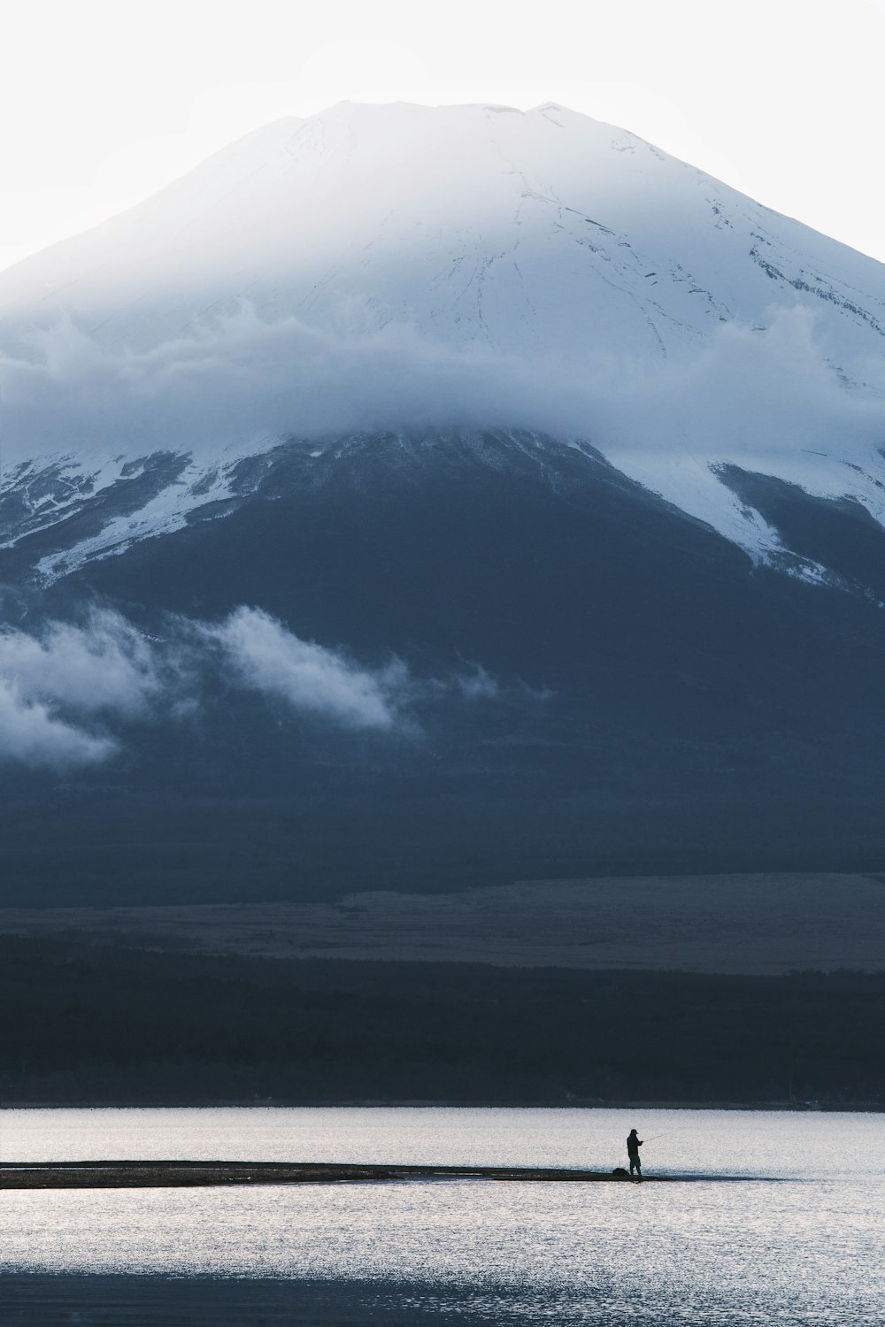 snow covered mountain under cloudy sky during daytime