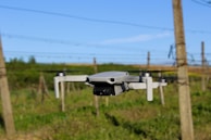 A drone hovering above a vineyard, monitoring crop health with sensors.