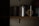 A dimly lit shelf displaying several cans of paint. The labels indicate brands such as Porter's Paints and Farrow & Ball. The cans are organized in a row, with some text partially visible due to the lighting.