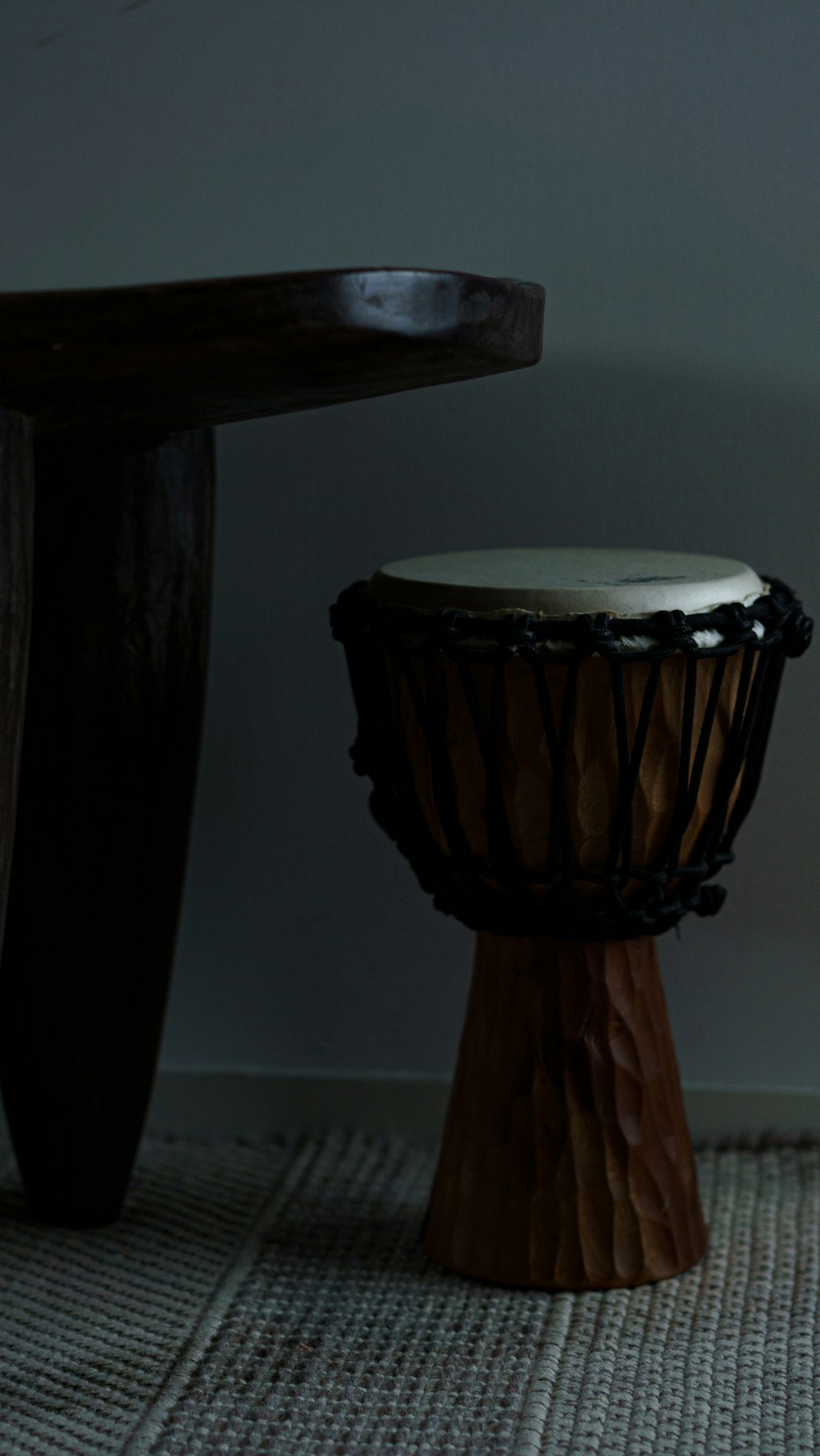 black and white drum near white wall