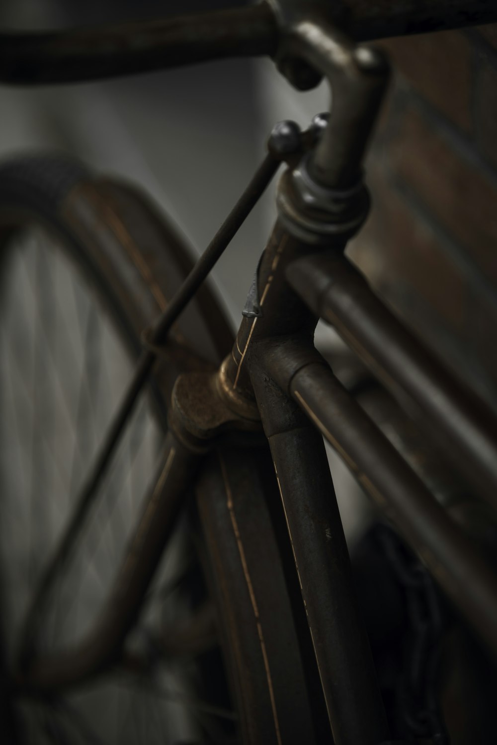 black bicycle wheel beside brown wooden fence