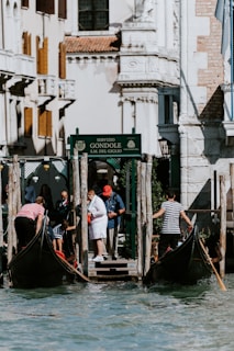 Happy passengers boarding a comfortable taxi in front of Venice airport at sunset.