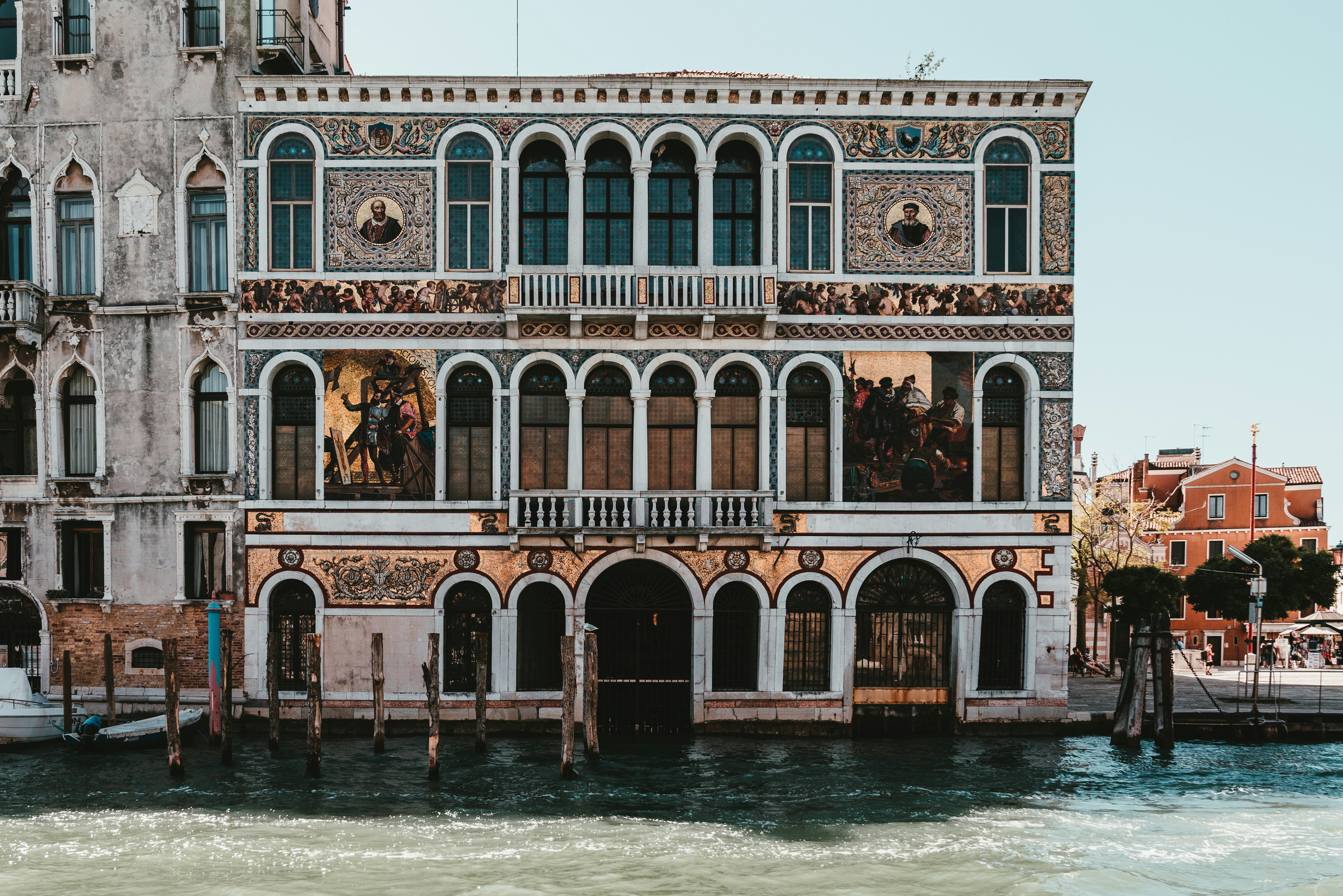 brown concrete building near body of water during daytime