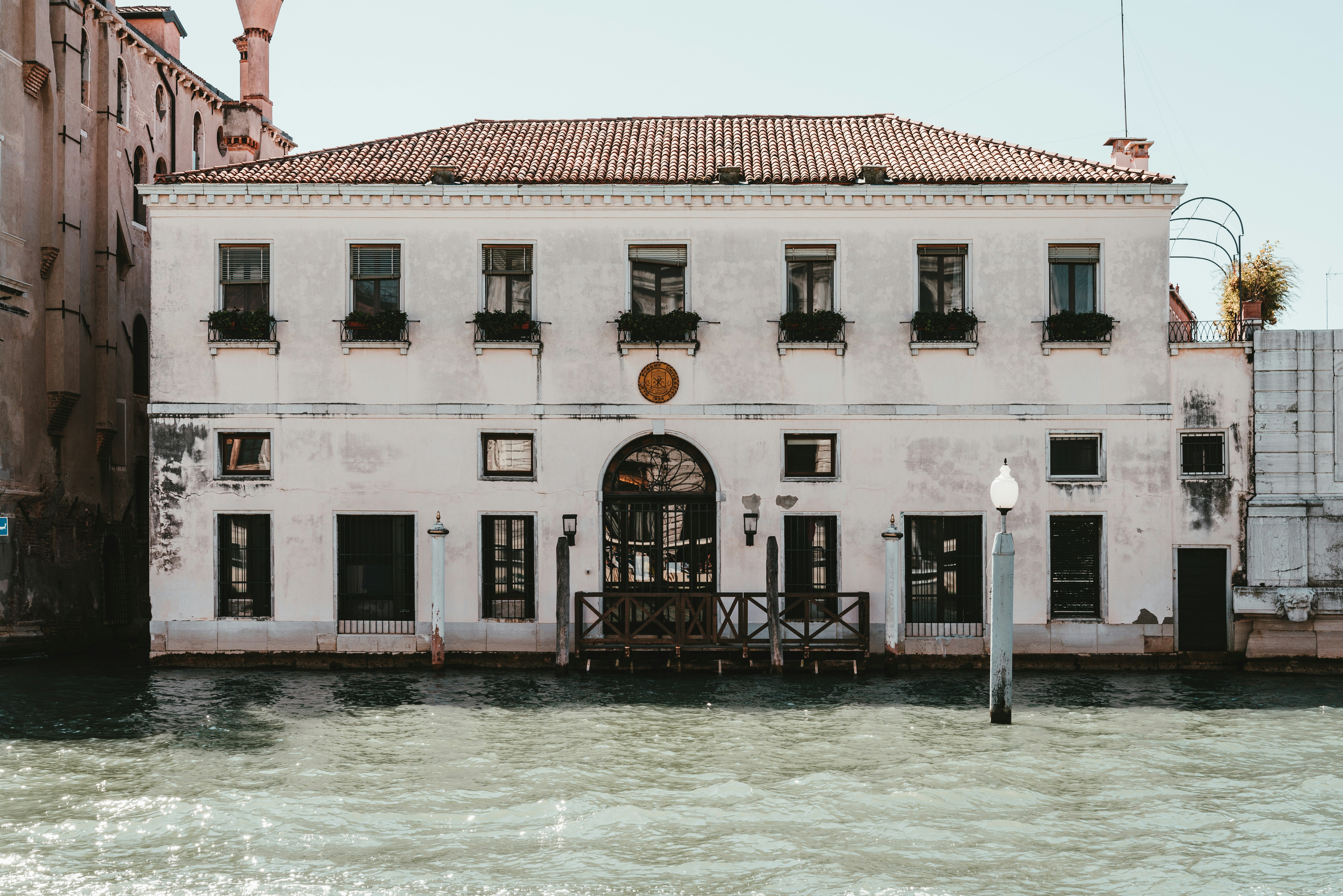 white and brown concrete building near body of water during daytime, 