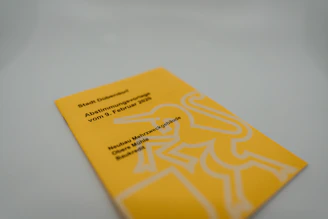 yellow and white book on white table
