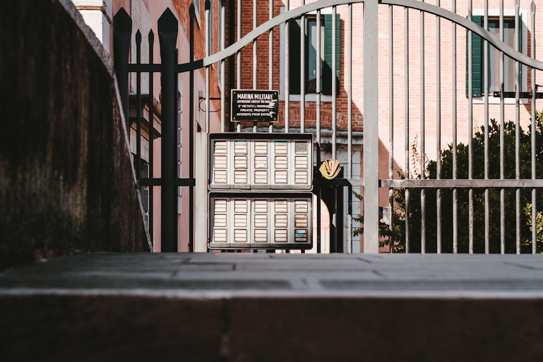 black metal gate near brown concrete building during daytime