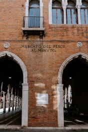 brown brick building with black metal fence