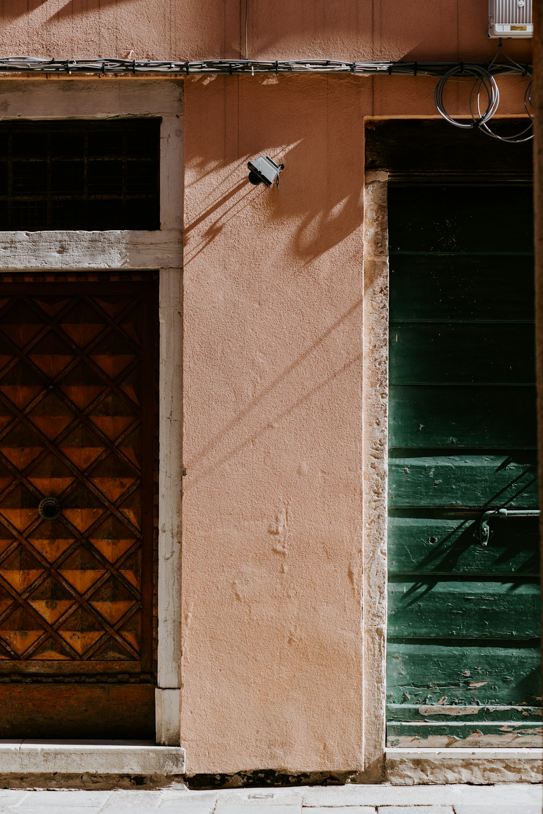 brown brick wall with green wooden window