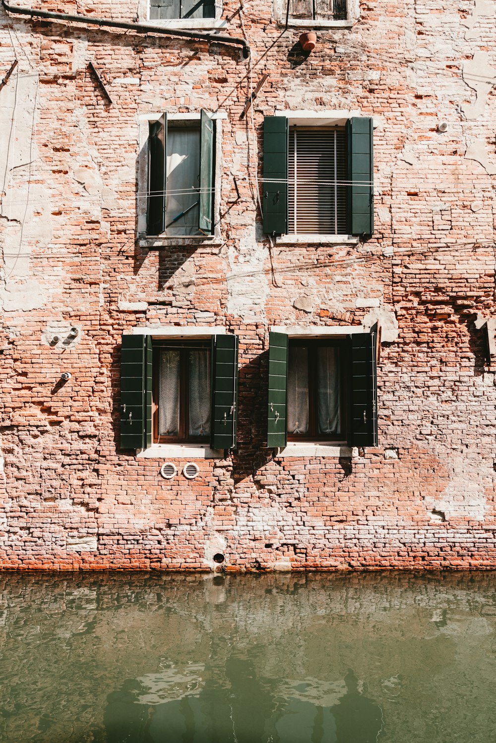 brown brick building with black window