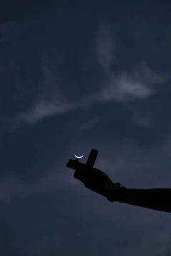 Hands holding a glowing cross symbolizing faith and commitment.