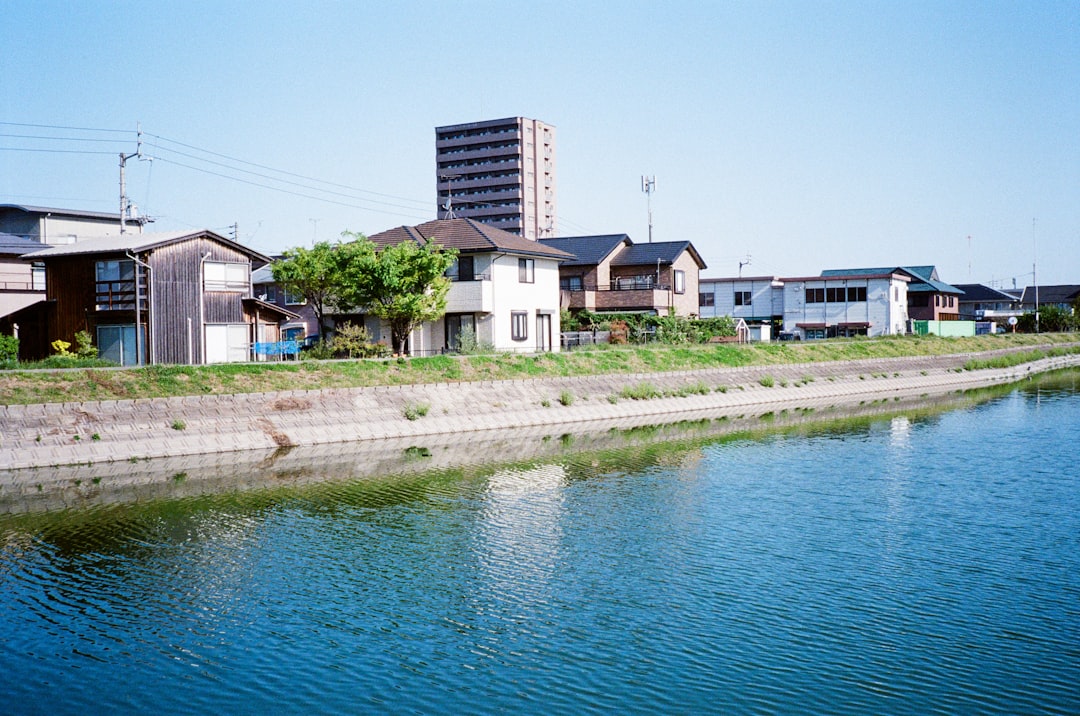 white and brown concrete building beside body of water during daytime