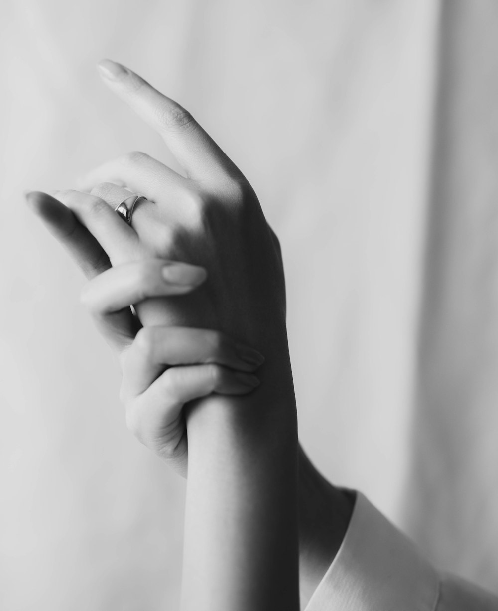 grayscale photo of persons hand