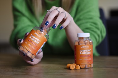 person holding orange labeled bottle