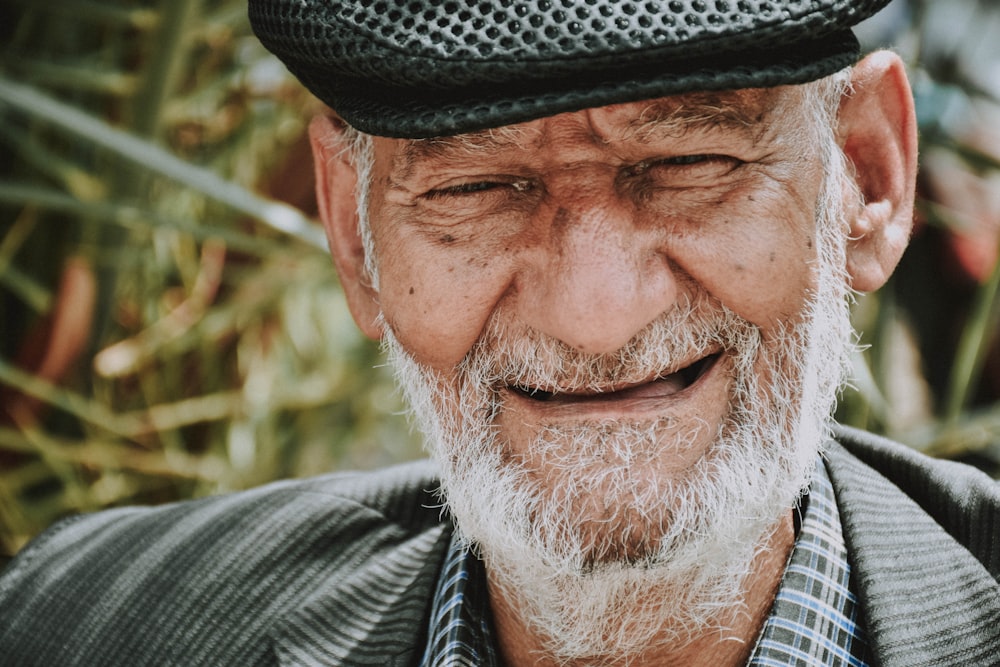 man in gray and black striped collared shirt wearing black fedora hat