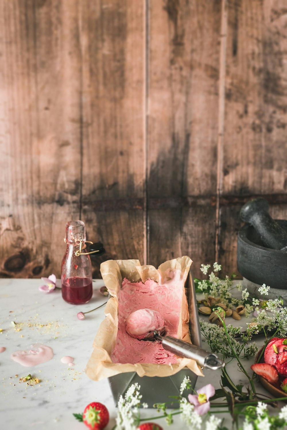 brown wooden chopping board beside clear glass bottle