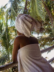 woman in white towel covering her face