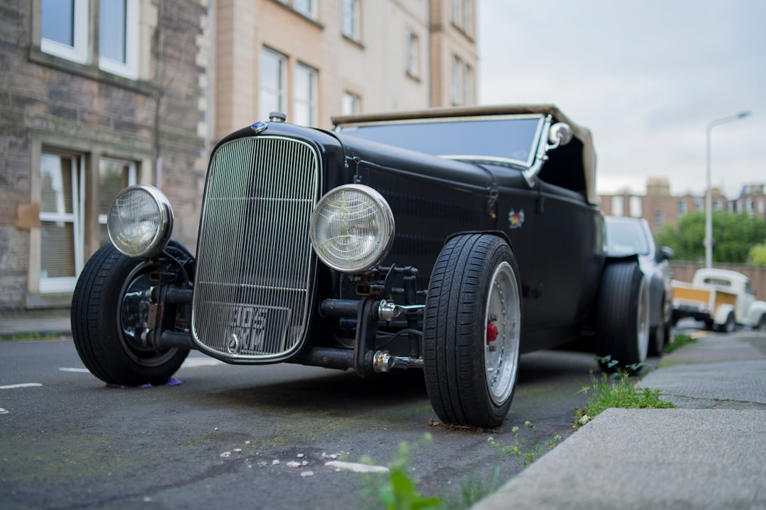 black vintage car parked near building during daytime