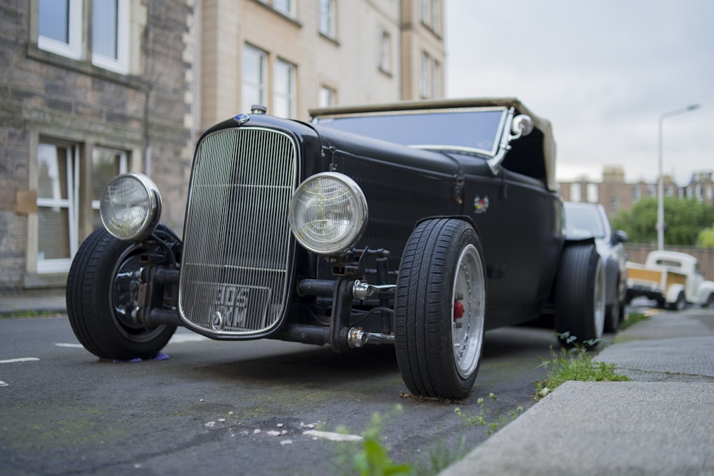 black vintage car parked near building during daytime