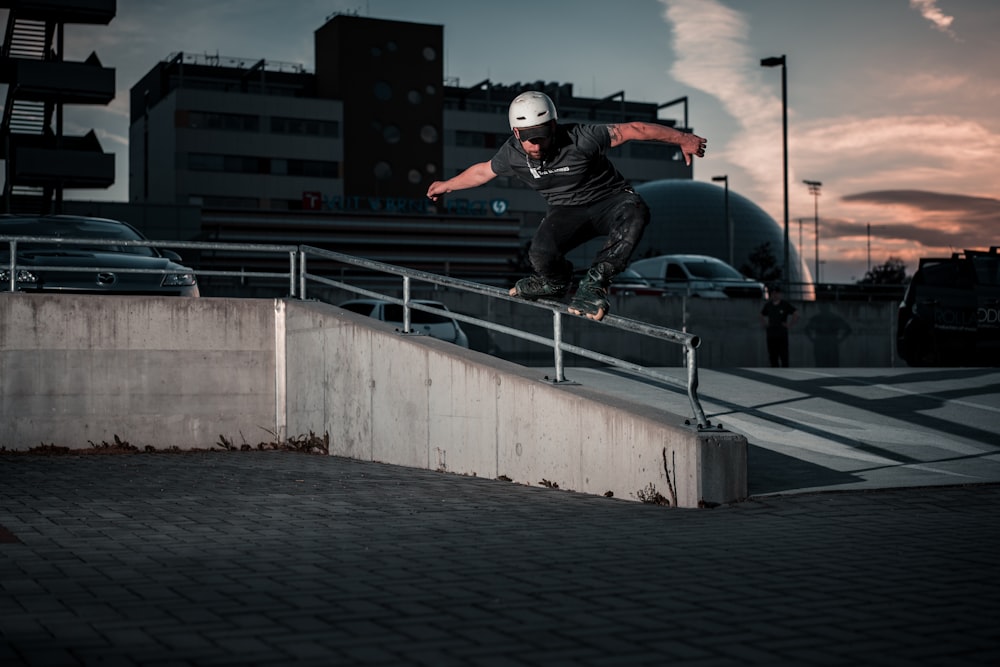 man in black jacket and helmet jumping on the bridge