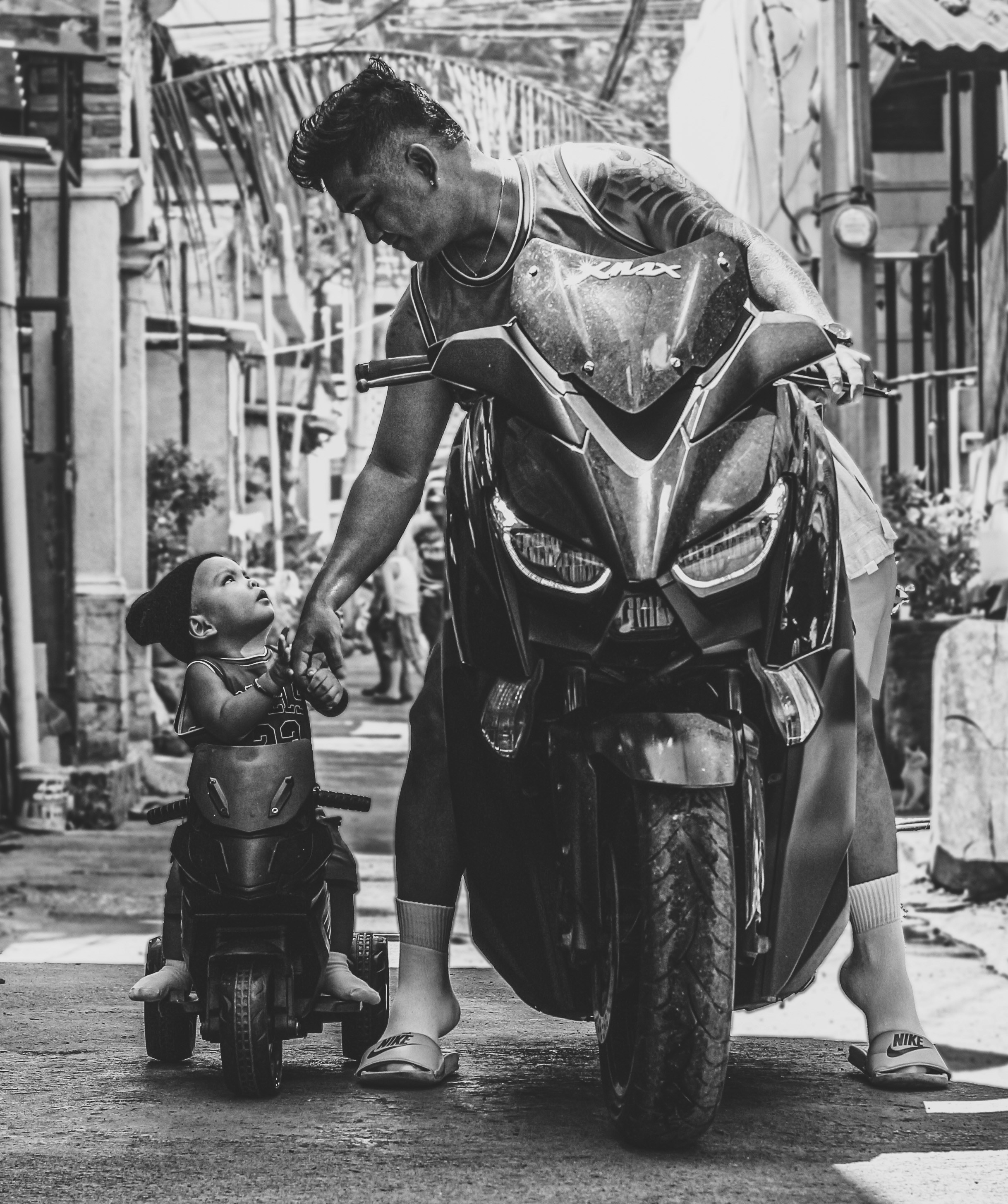 grayscale photo of man in helmet riding motorcycle