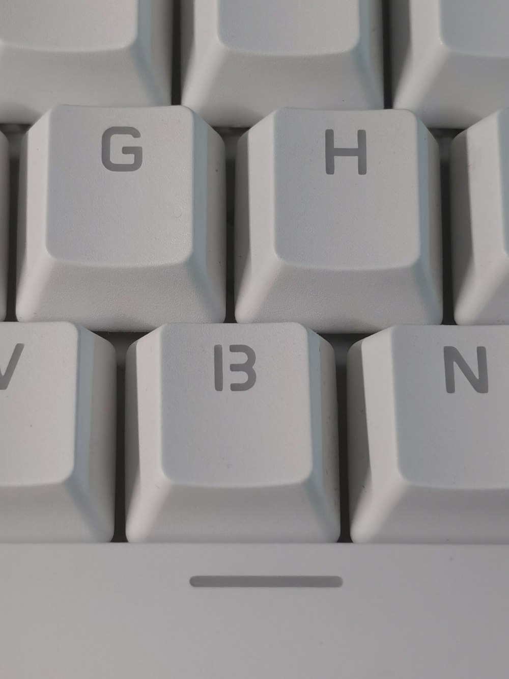 white computer keyboard showing letter b