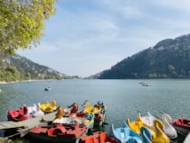 people riding on red kayak boat on sea during daytime