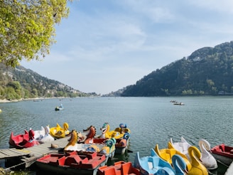 people riding on red kayak boat on sea during daytime