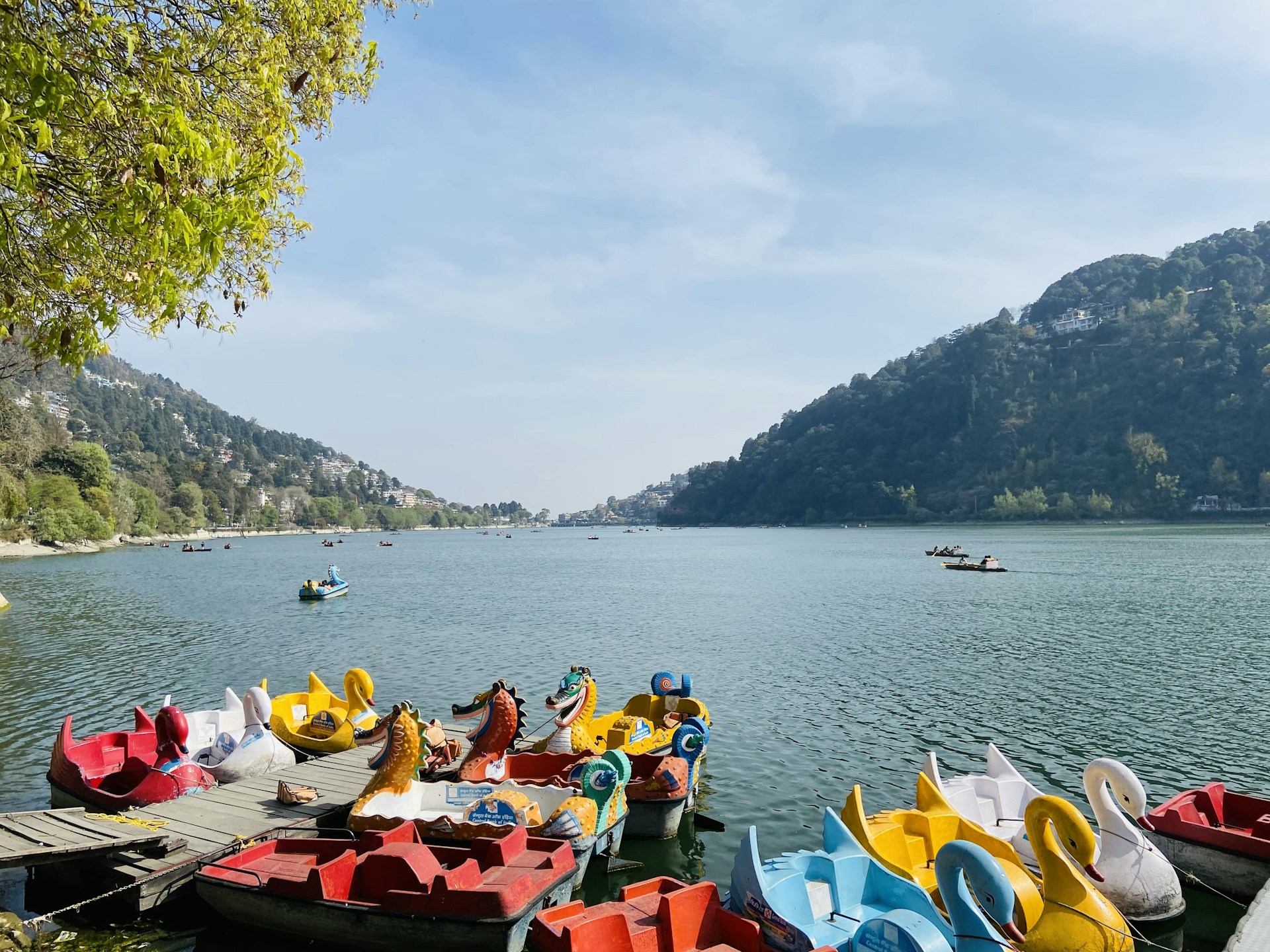 people riding on red kayak boat on sea during daytime