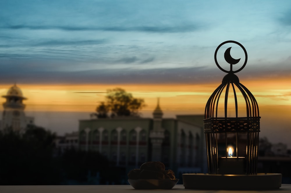 black metal candle lantern during sunset